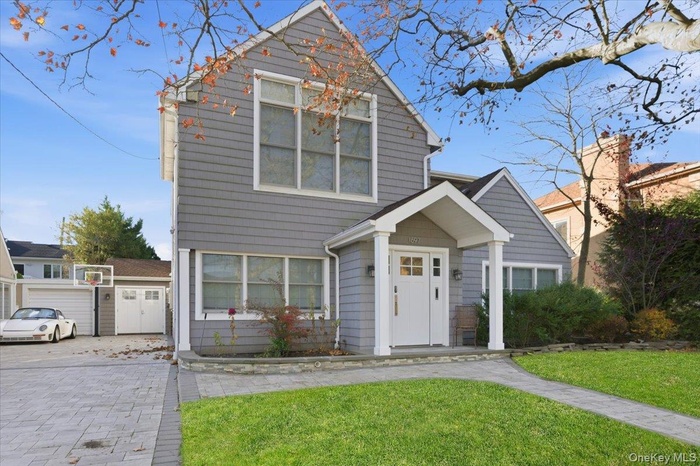 Traditional-style house with a front lawn