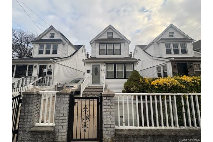 View of front facade with a gate and a fenced front yard