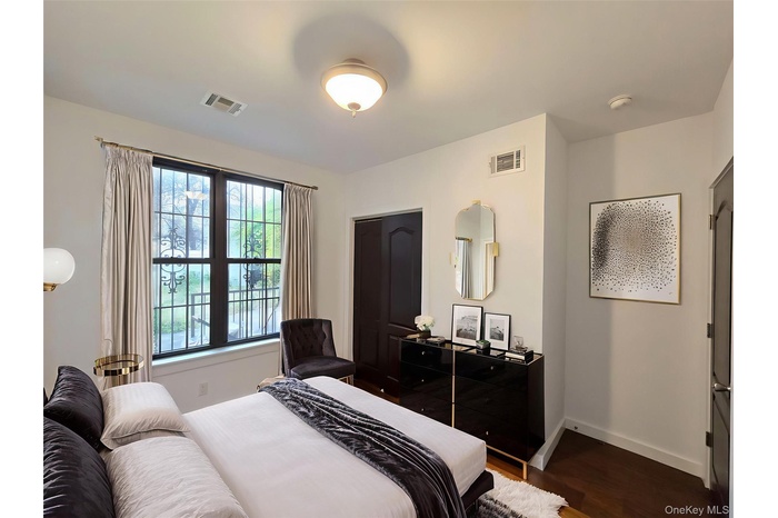 Bedroom with baseboards and wood finished floors