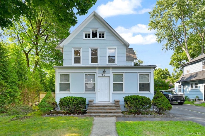 Traditional home with a front yard