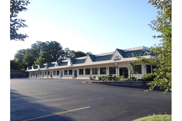 View of property with uncovered parking