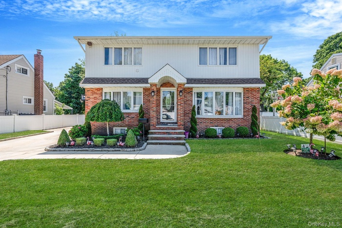Traditional home with brick siding and a shingled roof