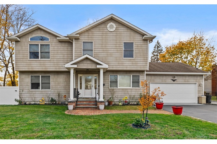 Colonial house with driveway and a garage