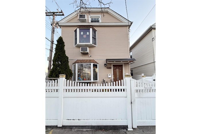 View of front facade featuring a gate and a fenced front yard