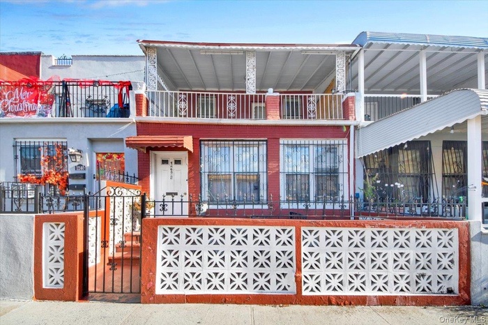 View of front facade with a fenced front yard and a gate