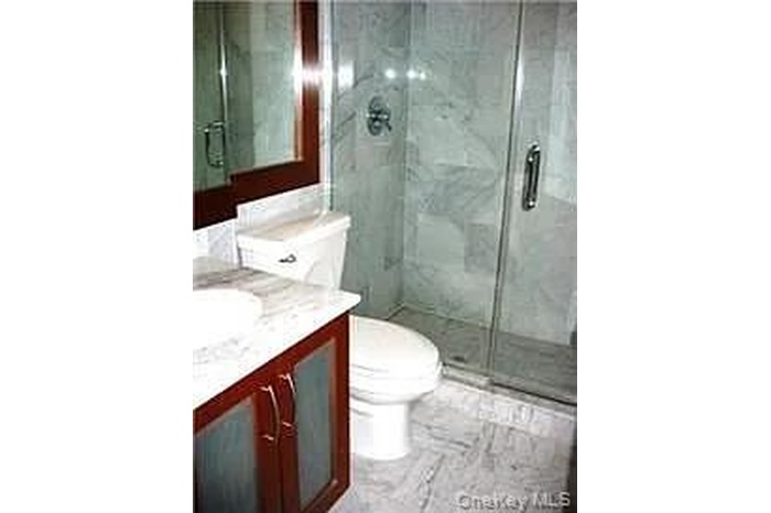 Full bathroom featuring a stall shower and vanity