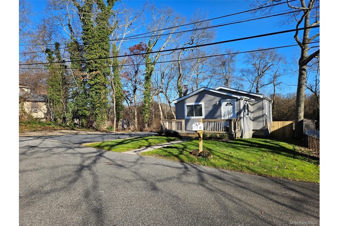 View of front of property featuring a front lawn and a chimney