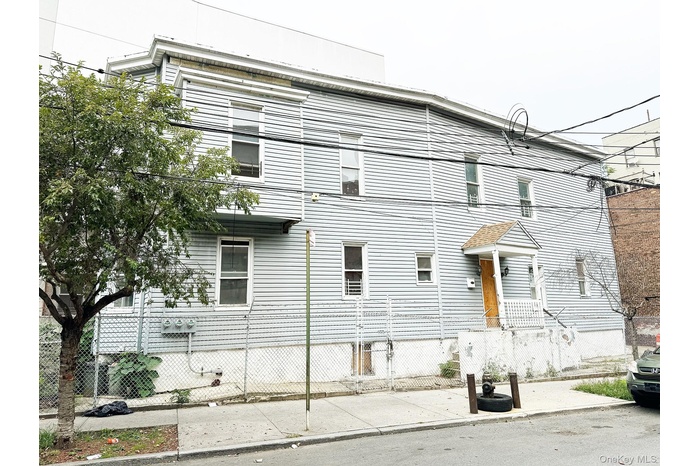 View of side of property featuring a fenced front yard