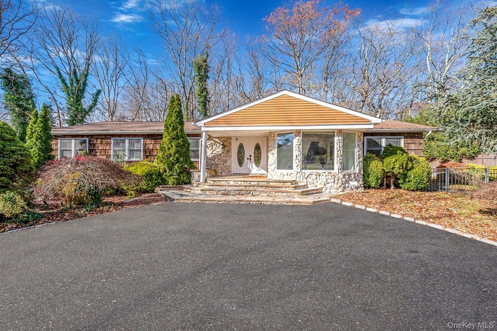 View of front of property with a porch and stone siding