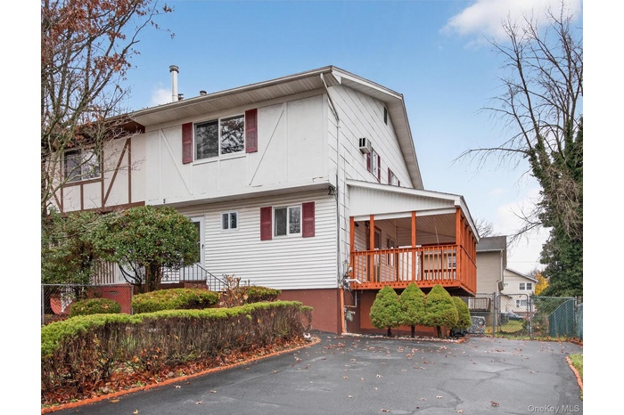 View of side of property with a gate