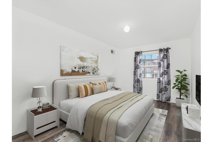 Bedroom featuring dark wood-style floors