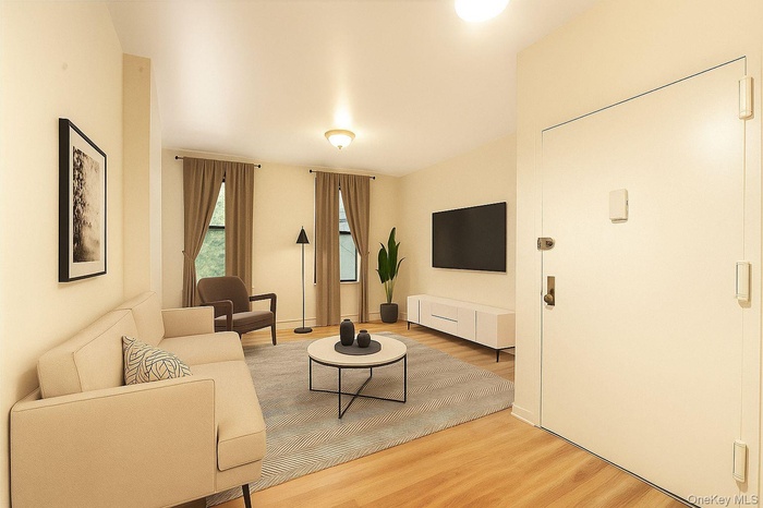 Virtually Staged - Living area with light wood-style floors