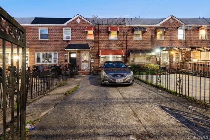 Traditional-style house featuring brick siding and driveway