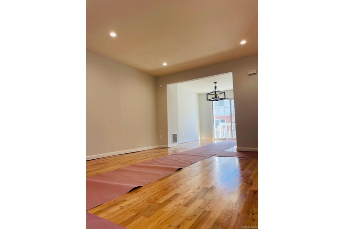 Unfurnished room featuring recessed lighting, light wood-type flooring, and a chandelier