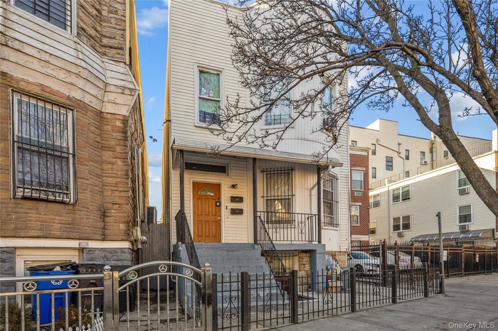 View of front of house featuring a fenced front yard and a gate