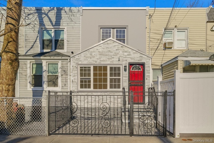 Traditional-style home featuring a fenced front yard and a gate