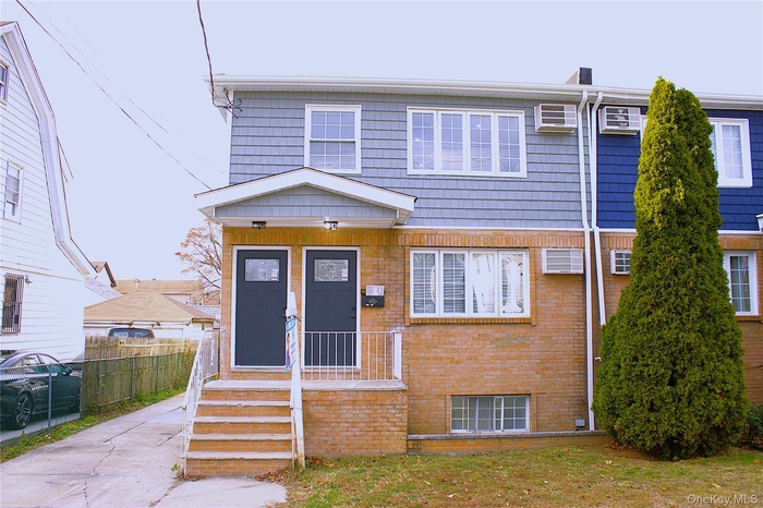 View of front of house featuring brick siding