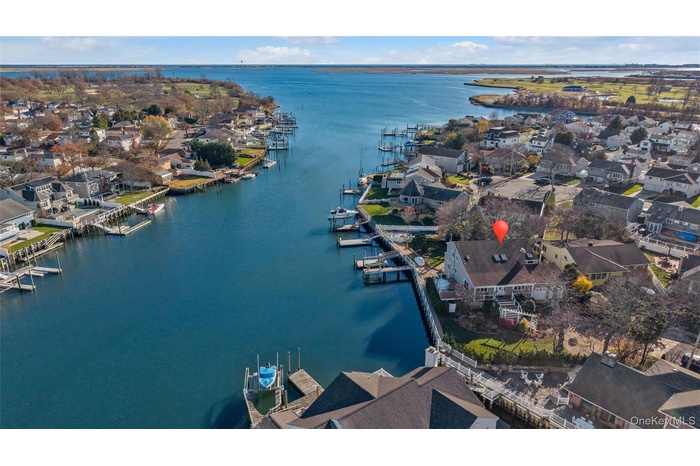 View of property location with a nearby body of water and nearby suburban area