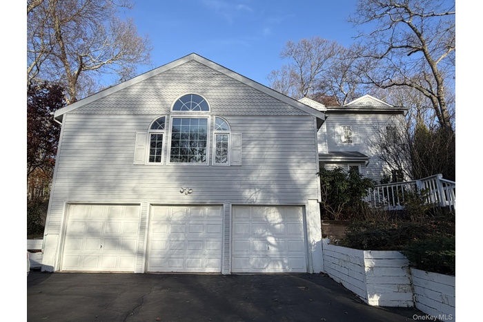 View of home's exterior featuring driveway and an attached garage