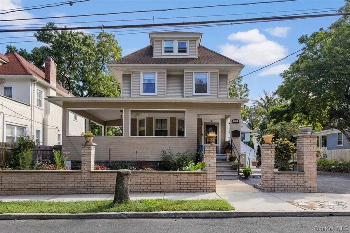 Traditional style home featuring a porch and a shingled roof