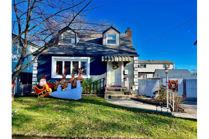 View of front facade featuring a chimney