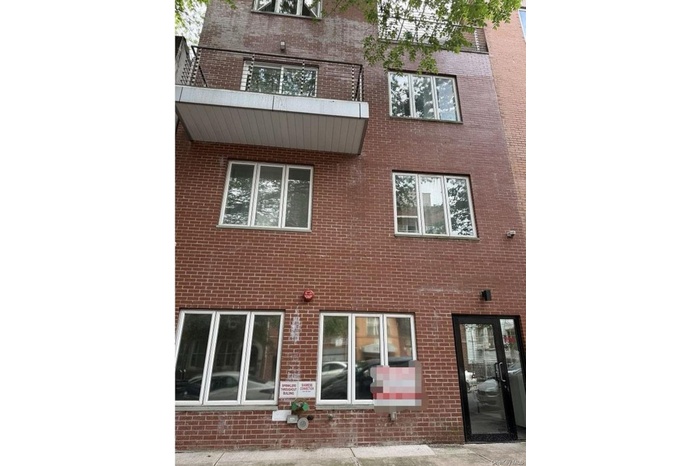 Rear view of house featuring brick siding