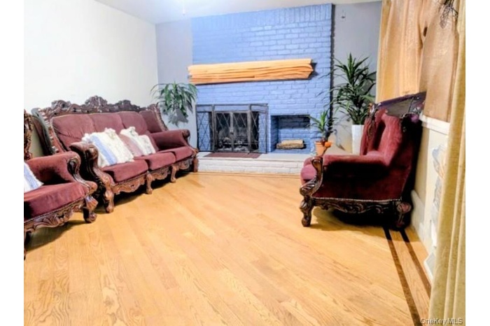 Living room with a fireplace and wood finished floors