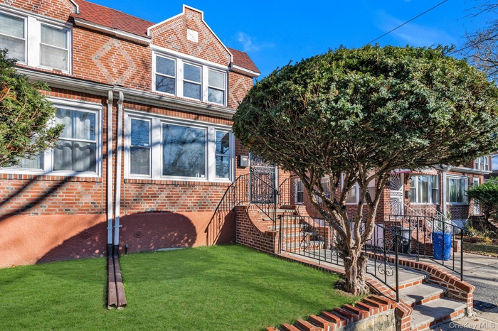 View of front of home featuring brick siding and a front lawn