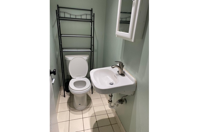 Bathroom featuring light tile patterned floors and toilet