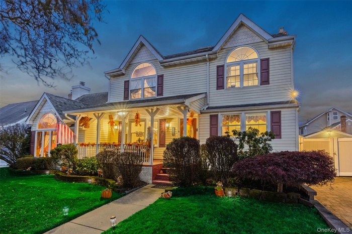 Victorian-style house with a front yard and covered porch