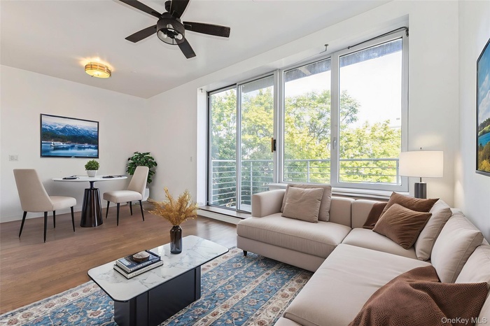 Living room with a ceiling fan and wood finished floors