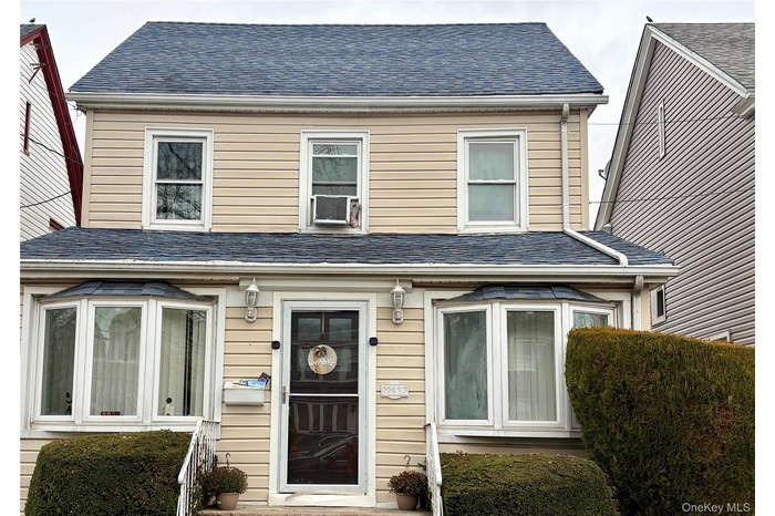 View of front facade featuring roof with shingles