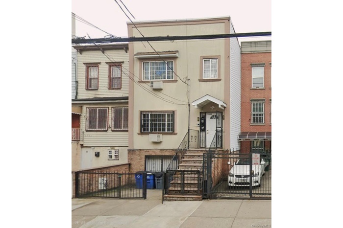 Traditional-style house featuring a fenced front yard, a gate, and stucco siding