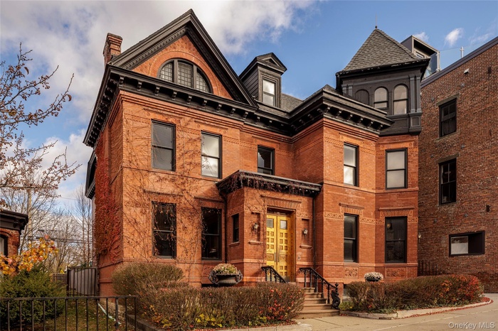 Victorian home with brick siding