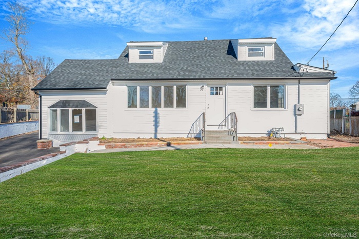View of front of house featuring roof with shingles