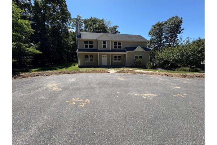 View of front of property with a chimney and a porch