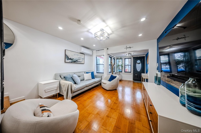 Living area featuring light wood finished floors, recessed lighting, and mini split systems