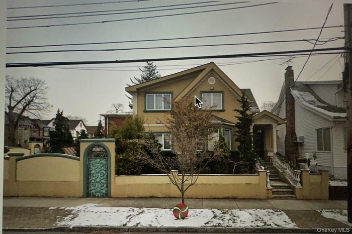 View of front of home with a fenced front yard, stucco siding, and a gate