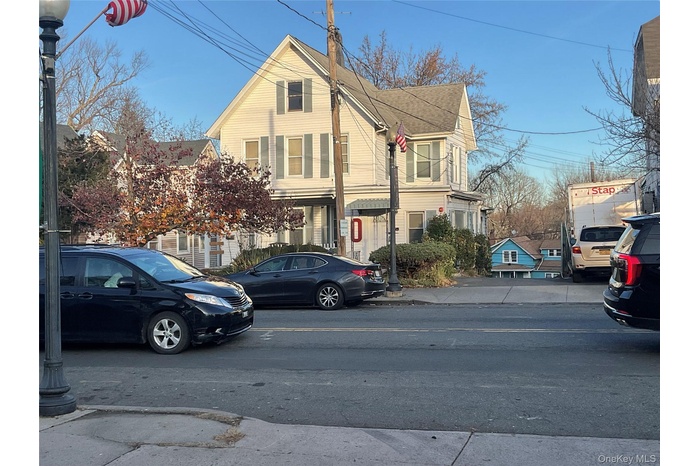 View of front of home with roof with shingles and a residential view