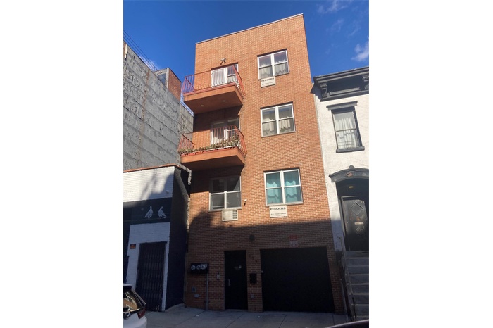 View of building exterior with a garage