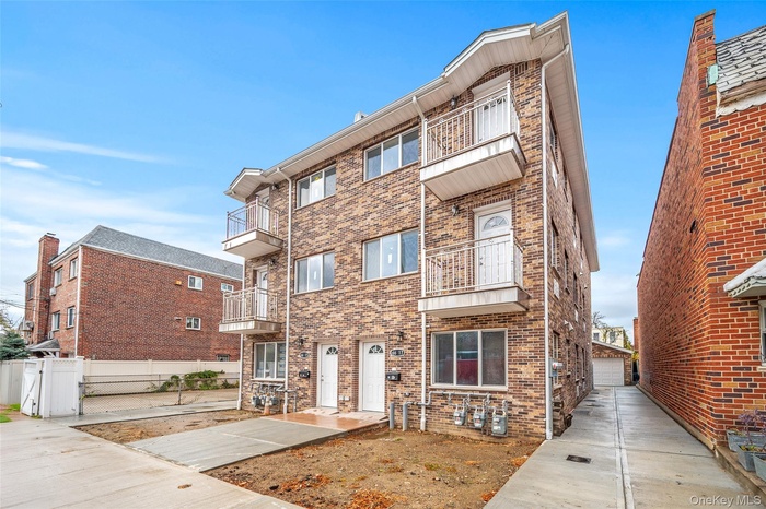 View of apartment building / complex with a garage