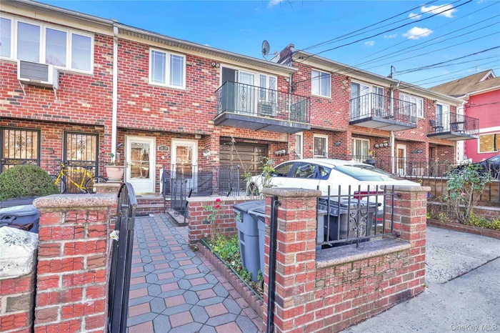 Traditional-style house with a balcony and brick siding