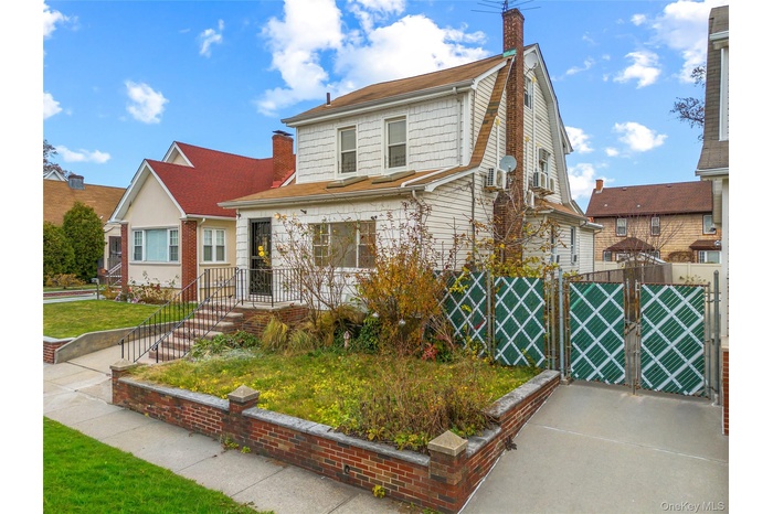View of front of house featuring a gate and a chimney
