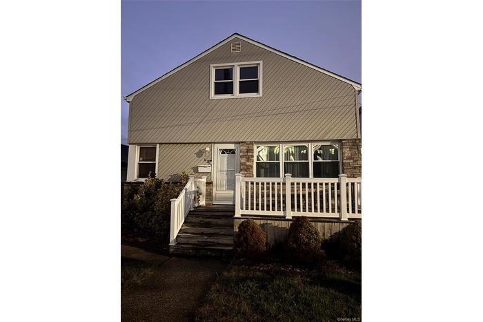 View of front of home featuring a deck and stone siding