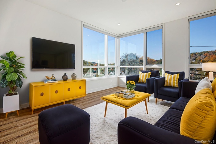 Living room featuring light hardwood / wood-style flooring, virtually staged