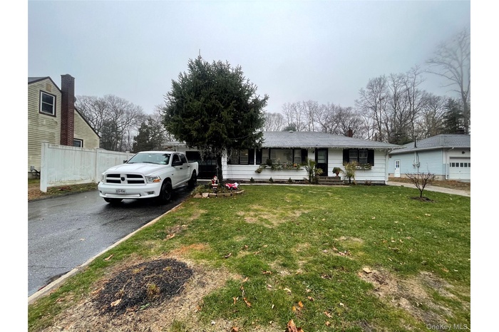 Single story home with asphalt driveway