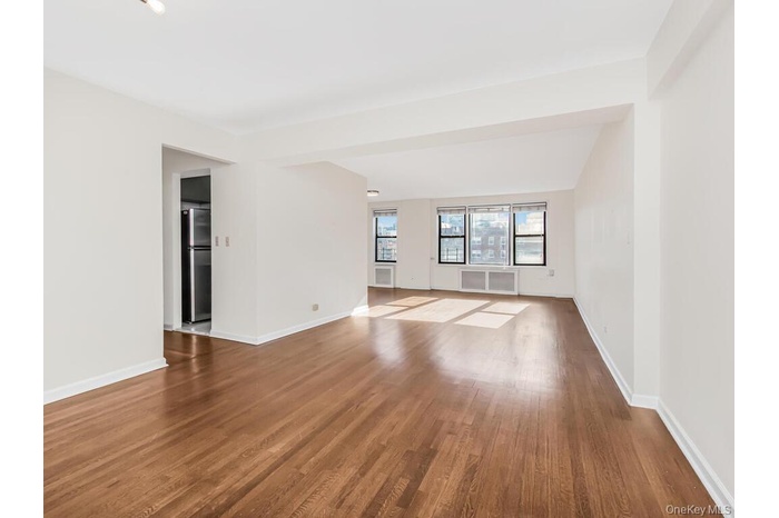 Unfurnished room featuring wood finished floors and baseboards