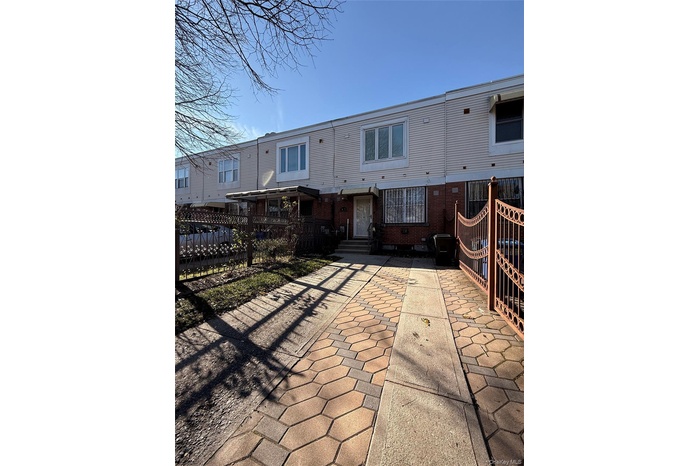 Rear view of house with a patio and brick siding