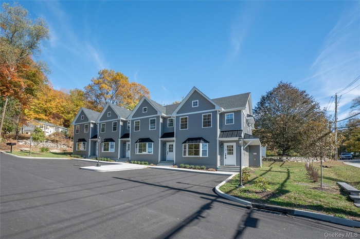 View of front of home with a residential view and a front lawn