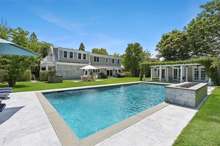 Outdoor pool featuring french doors, a pergola, a yard, and a patio